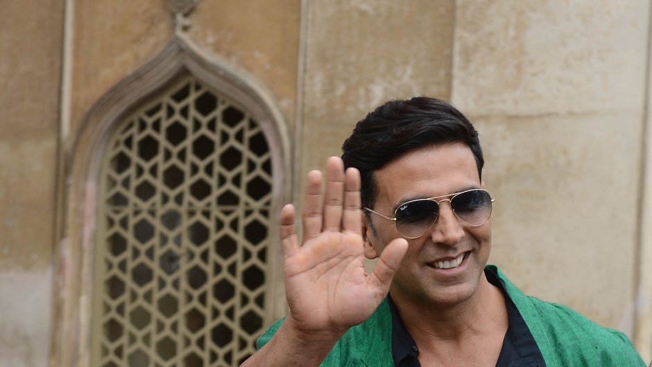 Indian Bollywood actor Akshay Kumar waves during a visit to the Charminar monument as he promotes his upcoming film BOSS in Hyderabad on October 11, 2013. AFP PHOTO / Noah SEELAM (Photo credit should read NOAH SEELAM/AFP/Getty Images)