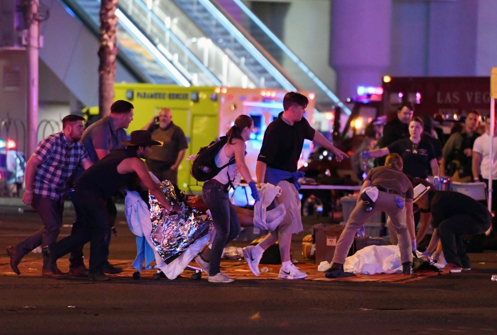 LAS VEGAS, NV - OCTOBER 02: An injured person is tended to in the intersection of Tropicana Ave. and Las Vegas Boulevard after a mass shooting at a country music festival nearby on October 2, 2017 in Las Vegas, Nevada. A gunman has opened fire on a music festival in Las Vegas, killing over 20 people. Police have confirmed that one suspect has been shot dead. The investigation is ongoing. (Photo by Ethan Miller/Getty Images)