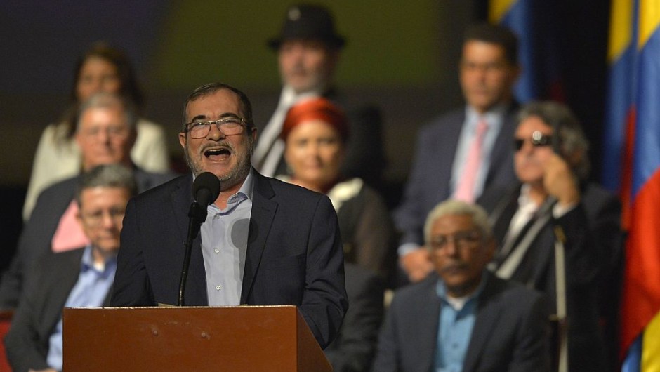 Head of the FARC guerrilla Timoleon Jimenez, aka Timochenko (front), delivers a speech after the signing of the historic peace agreement between the Colombian government and the Revolutionary Armed Forces of Colombia (FARC), at the Colon Theater in Bogota, Colombia, on November 24, 2016. Under pressure for fear that a fragile ceasefire could break down, the government and the Revolutionary Armed Forces of Colombia (FARC) sign the new deal and immediately take it to Congress. The plan bypasses a vote by the Colombian people after they unexpectedly rejected the first version of the deal in a referendum last month. The accord aims to end Latin America's last major armed conflict. But opponents say it is too soft on the leftist FARC force, blamed for many thousands of killings and kidnappings. / AFP / LUIS ROBAYO (Photo credit should read LUIS ROBAYO/AFP/Getty Images)