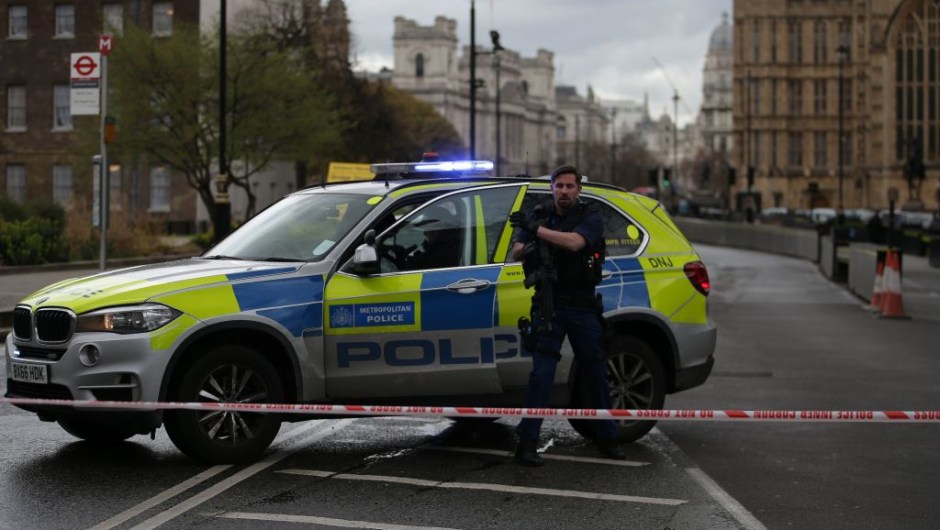 An armed police officer gets out of a car inside a police cordon outside the Houses of Parliament in central London on March 22, 2017 during an emergency incident. / AFP PHOTO / Daniel LEAL-OLIVAS (Photo credit should read DANIEL LEAL-OLIVAS/AFP/Getty Images)