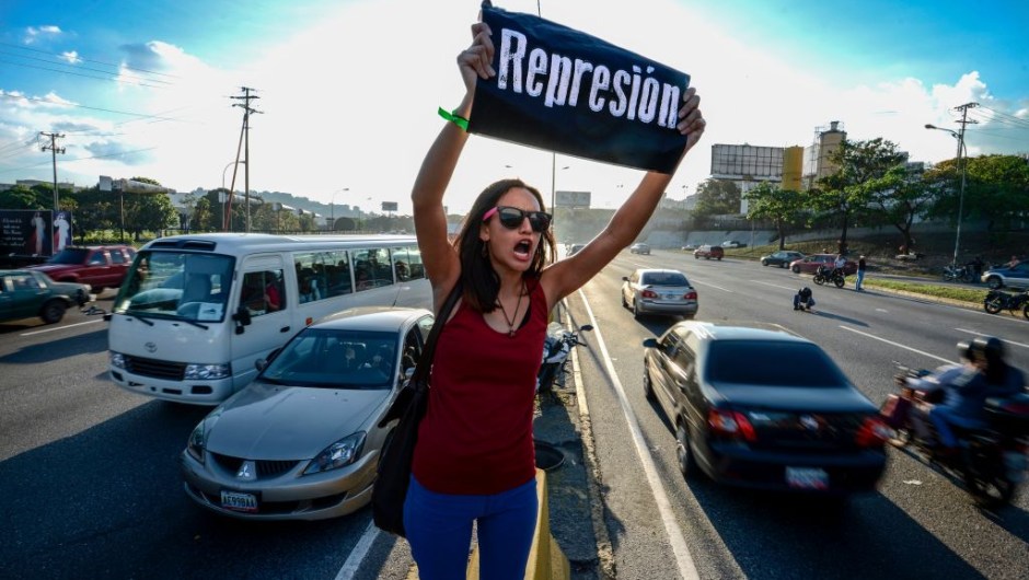 A student shouts slogans against Venezuelan President Nicola Maduro during a protest on the main highway in Caracas on March 30, 2017. Venezuela's Supreme Court took over legislative powers Wednesday from the opposition-majority National Assembly, whose speaker accused leftist President Nicolas Maduro of staging a "coup." / AFP PHOTO / Juan BARRETO (Photo credit should read JUAN BARRETO/AFP/Getty Images)