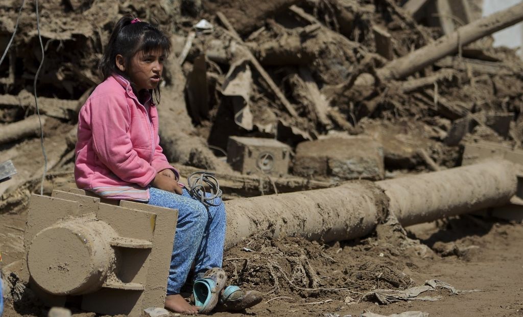 A girl sits amid the debris left by mudslides caused by heavy rains in Mocoa, Putumayo department, southern Colombia on April 4, 2017. The Colombian government on Monday declared a state of economic emergency in the town of Mocoa in southern Colombia, after mudslides left more than 270 people dead, including 43 children. / AFP PHOTO / LUIS ROBAYO (Photo credit should read LUIS ROBAYO/AFP/Getty Images)
