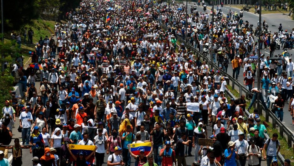 Opposition demonstrators march in Caracas on April 26, 2017. Protesters in Venezuela plan a high-risk march against President Maduro Wednesday, sparking fears of fresh violence after demonstrations that have left 26 dead in the crisis-wracked country. The placard reads "Jailed Students and Loose Delinquents" / AFP PHOTO / JUAN BARRETO (Photo credit should read JUAN BARRETO/AFP/Getty Images)
