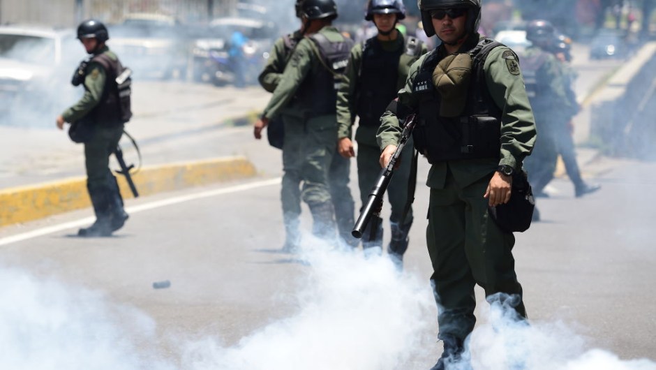 Riot police stand amid a cloud of tear gas on opponents of Venezuelan President Nicolas Maduro marching in Caracas on April 26, 2017. Protesters in Venezuela plan a high-risk march against President Maduro Wednesday, sparking fears of fresh violence after demonstrations that have left 26 dead in the crisis-wracked country. / AFP PHOTO / RONALDO SCHEMIDT (Photo credit should read RONALDO SCHEMIDT/AFP/Getty Images)