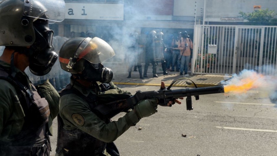 Members of the National Guard crack down on opposition demonstrators during a march against President Nicolas Maduro, in Caracas on April 26, 2017. Venezuelan riot police fired tear gas to stop anti-government protesters from marching on central Caracas, the latest clash in a wave of unrest that, up to now, has left 26 people dead. / AFP PHOTO / FEDERICO PARRA (Photo credit should read FEDERICO PARRA/AFP/Getty Images)