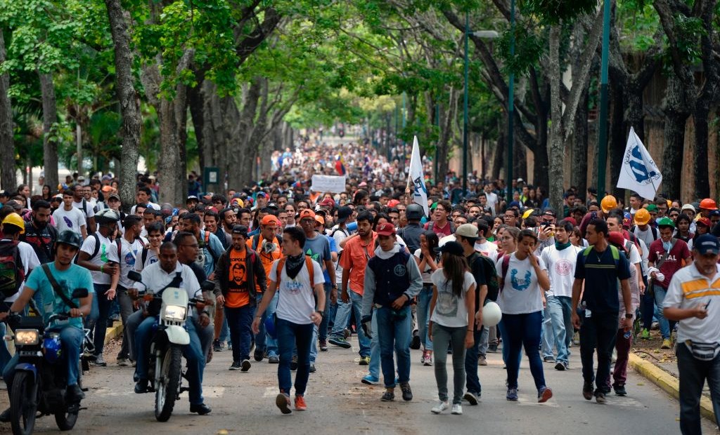 Venezuela's Central University students march to the education ministry, during a protest against President Nicolas Maduro, in Caracas on May 8, 2017. Venezuela's opposition mobilized Monday in fresh street protests against President Nicolas Maduro's efforts to reform the constitution in a deadly political crisis. Supporters of the opposition Democratic Unity Roundtable (MUD) gathered in eastern Caracas to march to the education ministry under the slogan "No to the dictatorship." / AFP PHOTO / FEDERICO PARRA (Photo credit should read FEDERICO PARRA/AFP/Getty Images)