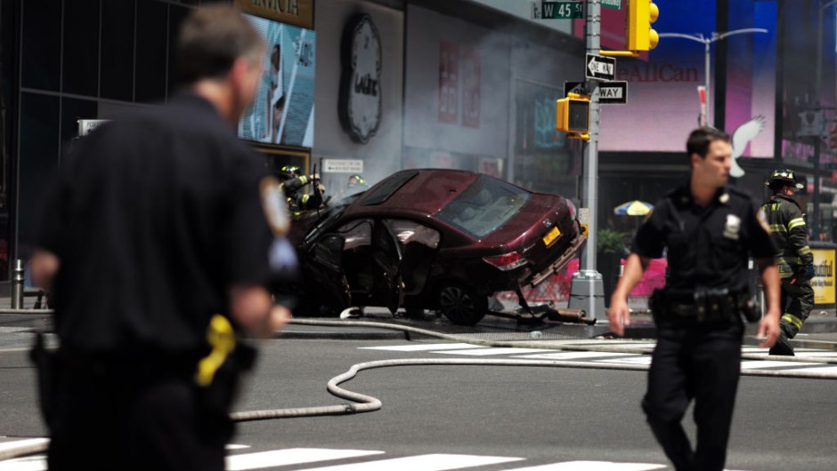 TOPSHOT - Police secure an are near a car after it plunged into pedestrians in Times Square in New York on May 18, 2017. A speeding car struck pedestrians in New York's Times Square on, killing one person and injuring 12 others in an accident in one of Manhattan's most popular tourists spots, officials said. / AFP PHOTO / Jewel SAMAD (Photo credit should read JEWEL SAMAD/AFP/Getty Images)