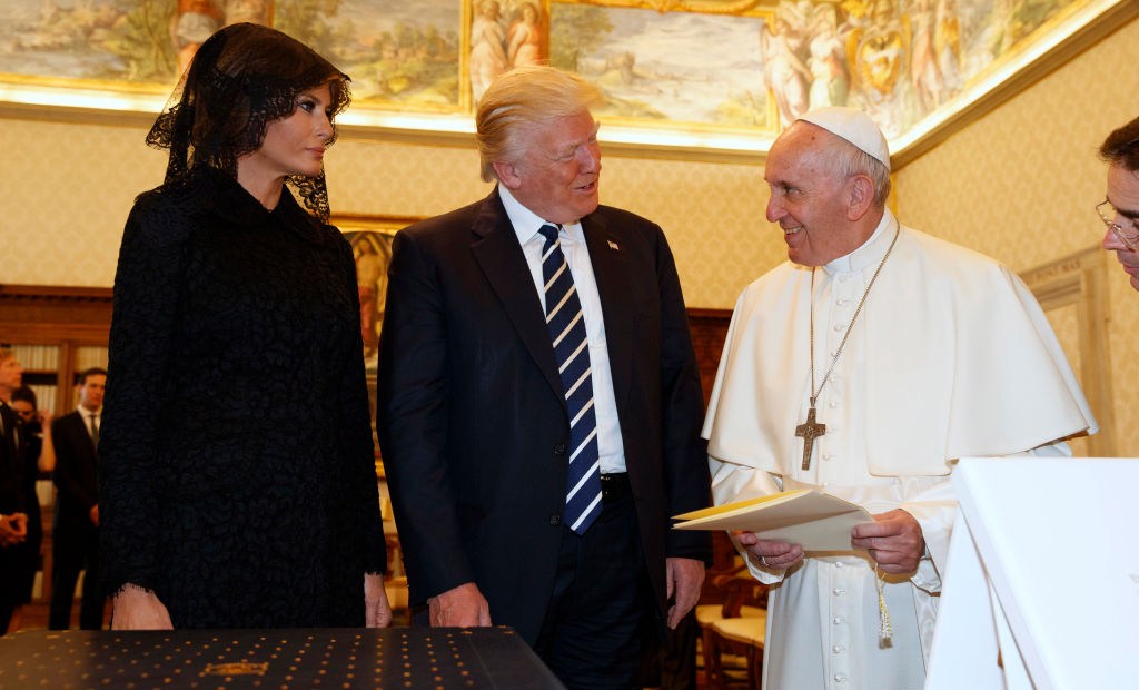 Pope Francis (R) exchanges gifts with US President Donald Trump and US First Lady Melania Trump during a private audience at the Vatican on May 24, 2017. US President Donald Trump met Pope Francis at the Vatican today in a keenly-anticipated first face-to-face encounter between two world leaders who have clashed repeatedly on several issues. / AFP PHOTO / POOL / Evan Vucci (Photo credit should read EVAN VUCCI/AFP/Getty Images)