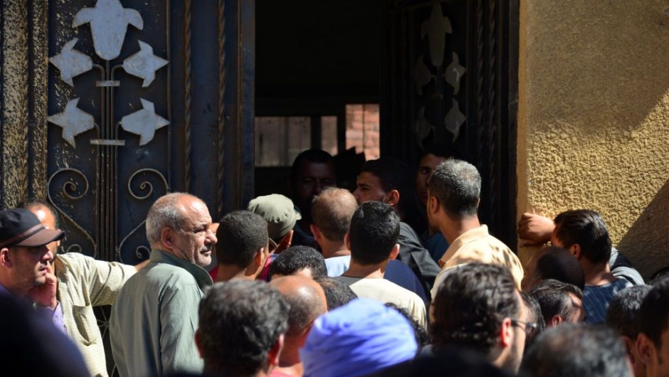 Egyptians wait outside a hospital to retreive some of the bodies of the victims of an attack, in which 28 Coptic pilgirms were gunned down following a visit to a monastery, in Idwah district of the Minya province, some 260 kms south of the capital Cairo, on May 26, 2017. The assailants in three pick-up trucks attacked the bus as it carried visitors to the Saint Samuel monastery in Minya province, more than 200 kilometres (120 miles) from Cairo, before fleeing, the interior ministry said. / AFP PHOTO / STRINGER (Photo credit should read STRINGER/AFP/Getty Images)
