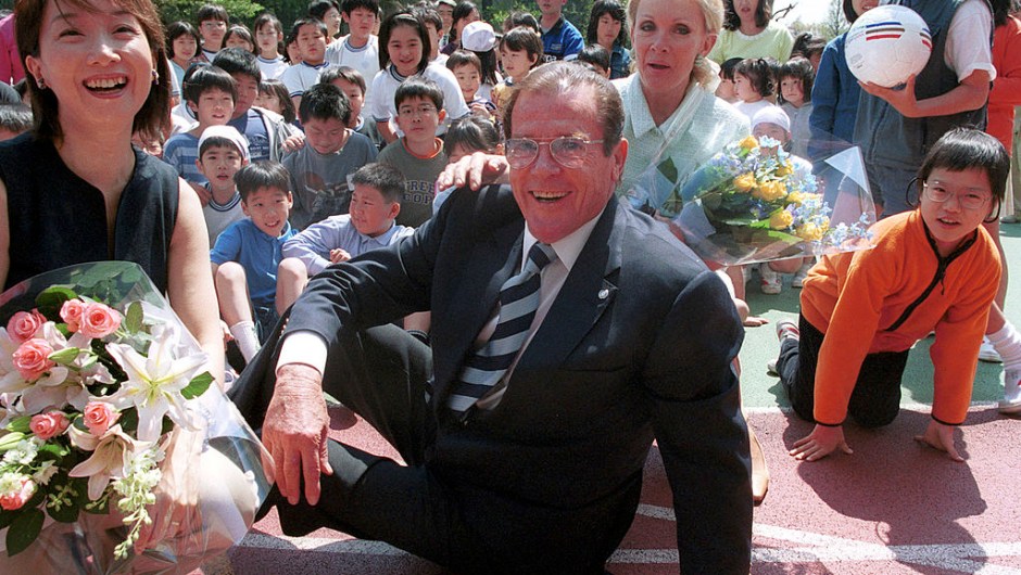 387893 01: Actor Roger Moore, who performed as the English spy James Bond in films in the 1970s and 1980s, meets with elementary school children as a UNICEF goodwill ambassador April 16, 2001 in Tokyo, Japan. Moore is visiting Japan to help promote awareness about an international conference, to be held in Yokohama in December, concerning the sexual exploitation of children. (Photo by Koichi Kamoshida/Newsmakers)