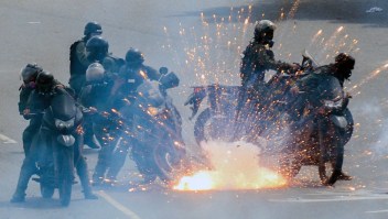 TOPSHOT - A firework launched by opposition activists explodes amid a group of National Guard riot police motorcyclists during a protest against President Nicolas Maduro's government, in Caracas on May 31, 2017. Venezuelan authorities on Wednesday began signing up candidates for a planned constitutional reform body, a move that has inflamed deadly unrest stemming from anti-government protests. Opponents of socialist President Nicolas Maduro say he aims to keep himself in power by stacking the planned "constituent assembly" with his allies. / AFP PHOTO / FEDERICO PARRA (Photo credit should read FEDERICO PARRA/AFP/Getty Images)
