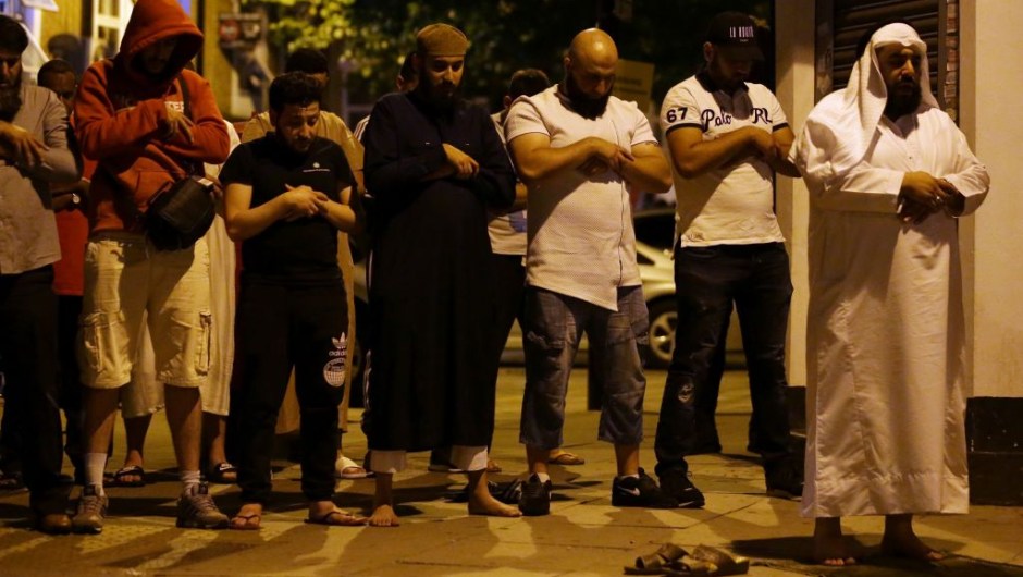 Muslims pray on a sidewalk in the Finsbury Park area of north London after a vehichle hit pedestrians, on June 19, 2017. One person has been arrested after a vehicle hit pedestrians in north London, injuring several people, police said Monday, as Muslim leaders said worshippers were mown down after leaving a mosque. / AFP PHOTO / Daniel LEAL-OLIVAS (Photo credit should read DANIEL LEAL-OLIVAS/AFP/Getty Images)