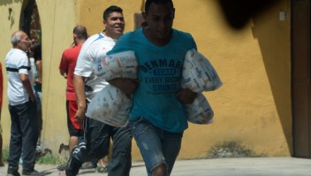 People carry stolen merchandise during lootings in Maracay, Aragua State, Venezuela on June 27, 2017. A political and economic crisis in the oil-producing country has spawned often violent demonstrations by protesters demanding President Nicolas Maduro's resignation and new elections. The unrest has left 76 people dead since April 1. / AFP PHOTO / Federico PARRA (Photo credit should read FEDERICO PARRA/AFP/Getty Images)