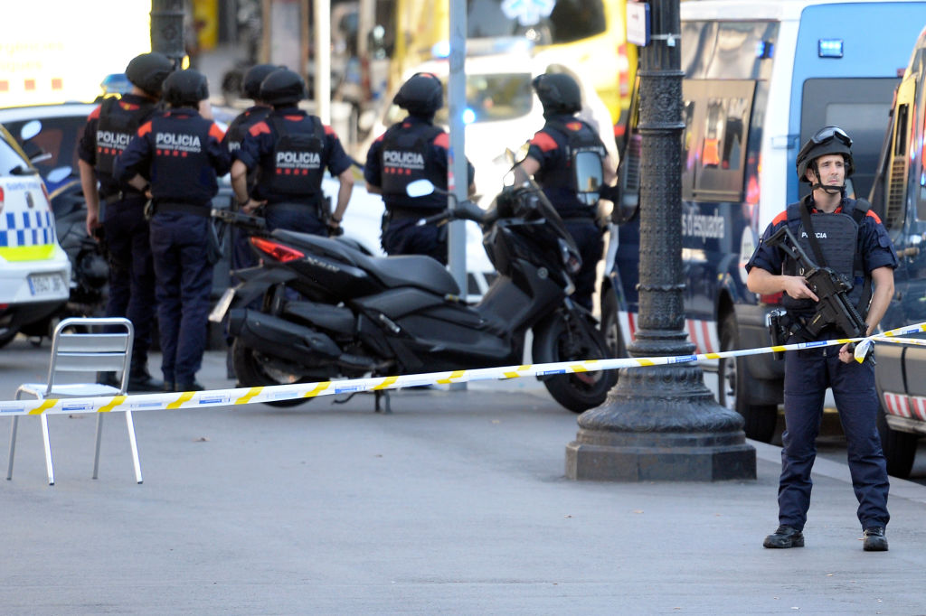 Armed policemen stand in a cordoned off area after a van ploughed into the crowd, injuring several persons on the Rambla in Barcelona on August 17, 2017. Police in Barcelona said they were dealing with a "terrorist attack" after a vehicle ploughed into a crowd of pedestrians on the city's famous Las Ramblas boulevard on August 17, 2017. Police were clearing the area after the incident, which has left a number of people injured. / AFP PHOTO / Josep LAGO (Photo credit should read JOSEP LAGO/AFP/Getty Images)