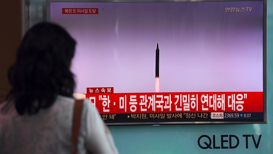 A woman watches a screen showing file footage of a North Korean missile launch, at a railway station in Seoul on September 15, 2017. North Korea fired an intermediate range ballistic missile eastwards over Japan and into the Pacific on September 15, the US said, its latest provocation amid high tensions over its banned weapons programmes. / AFP PHOTO / JUNG Yeon-Je (Photo credit should read JUNG YEON-JE/AFP/Getty Images)