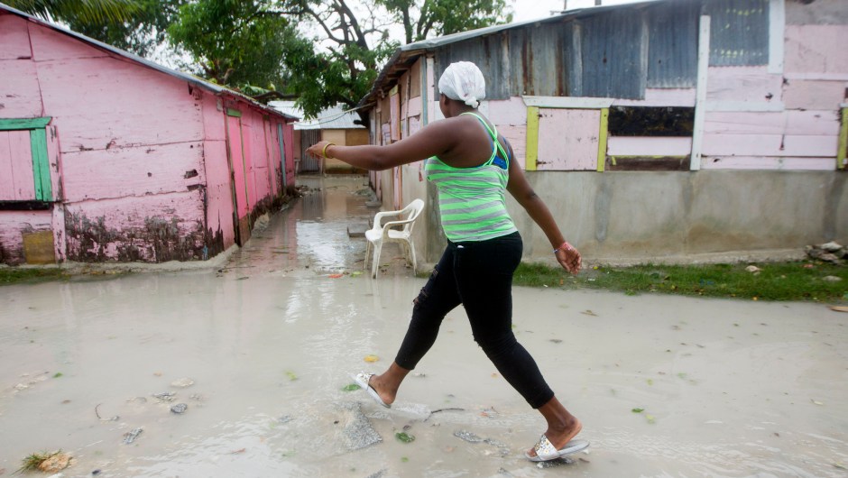 A woman walks along a flooded street in Punta Cana, in the Dominican Republic, as Hurricane Maria approaches on September 20, 2017. The government of the Dominican Republic told people to stay home from their public and private sector jobs on Thursday, when the hurricane is expected to hit the island. / AFP PHOTO / Erika SANTELICES (Photo credit should read ERIKA SANTELICES/AFP/Getty Images)