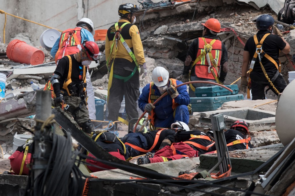 Rescuers work on the cleanup of a collapsed building in search of survivors in Mexico City on September 22, 2017. Hopes of finding more survivors after Mexico City's devastating quake dwindled to virtually nothing on Sunday, five days after the 7.1 tremor rocked the heart of the mega-city, toppling dozens of buildings and killing more than 300 people. / AFP PHOTO / Guillermo Arias (Photo credit should read GUILLERMO ARIAS/AFP/Getty Images)