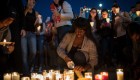 LAS VEGAS, NV - OCTOBER 2: Mourners light candles during a vigil at the corner of Sahara Avenue and Las Vegas Boulevard for the victims of Sunday night's mass shooting, October 2, 2017 in Las Vegas, Nevada. Late Sunday night, a lone gunman killed more than 50 people and injured more than 500 people after he opened fire on a large crowd at the Route 91 Harvest Festival, a three-day country music festival. The massacre is one of the deadliest mass shooting events in U.S. history. (Photo by Drew Angerer/Getty Images)