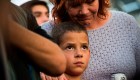 Nine-year old Alexander Wells is hugged by his grandmother at a candlelight vigil at Las Vegas City Hall October 2, 2017, after a gunman killed at least 58 people and wounded more than 500 others when he opened fire on a country music concert in Las Vegas, Nevada late October 1, 2017. Alexander had friends who were injured in another shooting recently and insisted on attending this vigil according to his family. / AFP PHOTO / Robyn Beck (Photo credit should read ROBYN BECK/AFP/Getty Images)