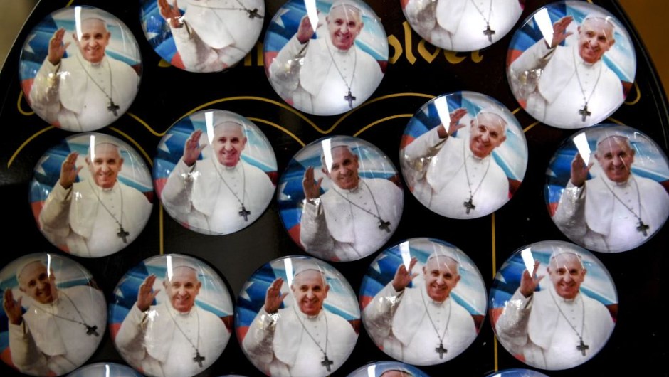 Pins of Pope Francis are sold at a street stall ahead of the pontiff's visit to Chile, in Santiago, on January 13, 2018. Pope Francis will be visiting Chile from January 15 to 18. / AFP PHOTO / Martin BERNETTI (Photo credit should read MARTIN BERNETTI/AFP/Getty Images)