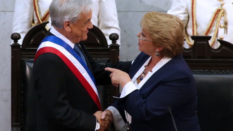TOPSHOT - Chilean new President Sebastian Pinera (L) is greeted by outgoing President Michelle Bachelet during his inauguration ceremony at the Congress in Valparaiso, Chile, on March 11, 2018. / AFP PHOTO / CLAUDIO REYES (Photo credit should read CLAUDIO REYES/AFP/Getty Images)