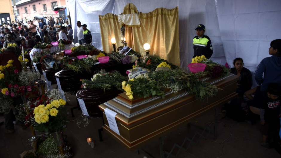 View of the coffins of seven people who died following the eruption of the Fuego volcano, at the morgue in Alotenango municipality, Sacatepequez, about 65 km southwest of Guatemala City, on June 4, 2018. - Rescue workers Monday pulled more bodies from under the dust and rubble left by an explosive eruption of Guatemala's Fuego volcano, bringing the death toll to at least 62. (Photo by JOHAN ORDONEZ / AFP) (Photo credit should read JOHAN ORDONEZ/AFP/Getty Images)