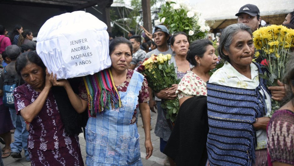 Two women carry the coffin of a little girl who died, following the eruption of the Fuego volcano, along the streets of Alotenango municipality, Sacatepequez, about 65 km southwest of Guatemala City, on June 4, 2018. - Rescue workers Monday pulled more bodies from under the dust and rubble left by an explosive eruption of Guatemala's Fuego volcano, bringing the death toll to at least 62. (Photo by JOHAN ORDONEZ / AFP) (Photo credit should read JOHAN ORDONEZ/AFP/Getty Images)