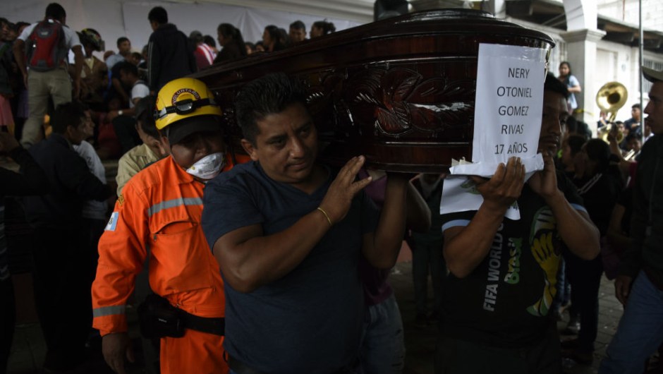 Residents and rescuers carry the coffin of one of the seven people who died following the eruption of the Fuego volcano, along the streets of Alotenango municipality, Sacatepequez, about 65 km southwest of Guatemala City, on June 4, 2018. - Rescue workers Monday pulled more bodies from under the dust and rubble left by an explosive eruption of Guatemala's Fuego volcano, bringing the death toll to at least 62. (Photo by JOHAN ORDONEZ / AFP) (Photo credit should read JOHAN ORDONEZ/AFP/Getty Images)
