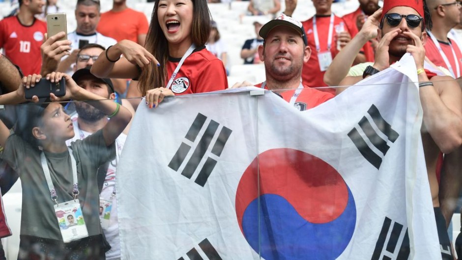 Fans hold the South Korea flag before the Russia 2018 World Cup Group A football match between Saudi Arabia and Egypt at the Volgograd Arena in Volgograd on June 25, 2018. (Photo by NICOLAS ASFOURI / AFP) / RESTRICTED TO EDITORIAL USE - NO MOBILE PUSH ALERTS/DOWNLOADS (Photo credit should read NICOLAS ASFOURI/AFP/Getty Images)