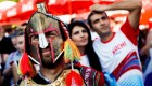 A Peruvian fan (L) stand in front of Russian football fans in the FIFA fan zone in Sochi on June 25, 2018, watching the Russia 2018 FIFA football World Cup group A match between Uruguay and Russia on a big screen. (Photo by Adrian DENNIS / AFP) (Photo credit should read ADRIAN DENNIS/AFP/Getty Images)