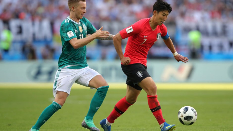 KAZAN, RUSSIA - JUNE 27: Heungmin Son of Korea Republic is challenged by Marco Reus of Germany during the 2018 FIFA World Cup Russia group F match between Korea Republic and Germany at Kazan Arena on June 27, 2018 in Kazan, Russia. (Photo by Alexander Hassenstein/Getty Images, )