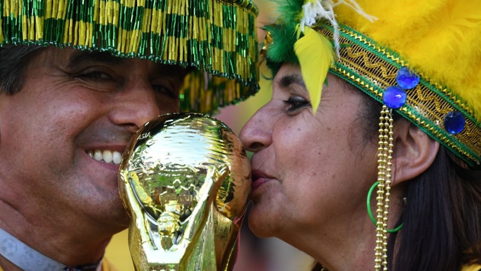 Brazilian fans kiss a replica of the FIFA World Cup trophy before the Russia 2018 World Cup Group E football match between Serbia and Brazil at the Spartak Stadium in Moscow on June 27, 2018. (Photo by Kirill KUDRYAVTSEV / AFP) / RESTRICTED TO EDITORIAL USE - NO MOBILE PUSH ALERTS/DOWNLOADS (Photo credit should read KIRILL KUDRYAVTSEV/AFP/Getty Images)