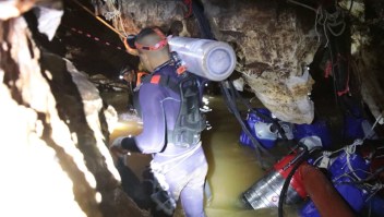 Emergency workers work to rescue the 12 trapped boys and their coach the in cave where water levels have significantly reduced.