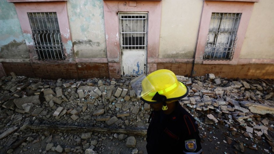 TOPSHOT - A firefighter walks in front of a house damaged during a 4.9 earthquake in Valencia, Carabobo State, Venezuela, on December 27, 2018. - A strong tremor followed by a score of aftershocks shook Caracas and several Venezuelan states early this Thursday, the Venezuelan Foundation for Seismological Research (Funvisis) reported. (Photo by JUAN CARLOS HERNANDEZ / AFP) (Photo credit should read JUAN CARLOS HERNANDEZ/AFP/Getty Images)