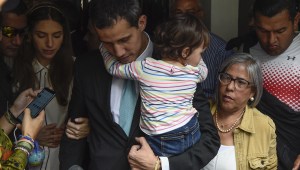 Opposition leader and self-proclaimed "acting president" Juan Guaido (C) holds his daughter Miranda, flanked by his wife Fabiana Rosales (L) and his mother Norka Marquez, outside his home in Santa Fe, Caracas on January 31, 2019. - Venezuela's self-proclaimed acting president Juan Guaido on Thursday accused socialist leader Nicolas Maduro's security forces of trying to intimidate his family. Guaido, the opposition leader challenging Maduro's rule, said the security service FAES had gone to his house asking for his wife, Fabiana. (Photo by Federico Parra / AFP) (Photo credit should read FEDERICO PARRA/AFP/Getty Images)