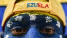 A man with his face painted with Venezuela's national colours, attends the "Venezuela Aid Live" concert, organized to raise money for the Venezuelan relief effort at Tienditas International Bridge in Cucuta, Colombia, on February 22, 2019. - Thousands of people, many waving Venezuelan flags, streamed into a concert site on the Venezuela-Colombia border Friday for an international charity concert to push for humanitarian aid deliveries in defiance of a blockade by the government of President Nicolas Maduro. (Photo by Luis ROBAYO / AFP) (Photo credit should read LUIS ROBAYO/AFP/Getty Images)
