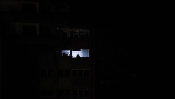 A man looks out of a window during a power outage in Caracas, Venezuela, on March 30, 2019. - Venezuelan security forces fired tear gas Saturday to disperse demonstrators in Caracas outraged by massive power outages that have kept much of the country in darkness since early March. (Photo by FEDERICO PARRA / AFP) (Photo credit should read FEDERICO PARRA/AFP/Getty Images)
