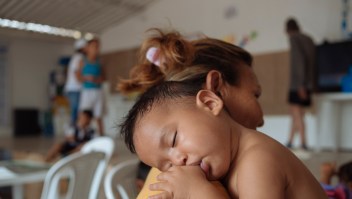 On 25 April 2019 in Colombia, a baby rests on his mother's shoulder at the Friendly Space (CATM) in Cucuta, where UNICEF provides learning activities for migrant children and parents from Venezuela. The programme is supported by UNICEF, in coordination with OIM and the Colombian Chancellery. In February 2019, countries in Latin America and the Caribbean are hosting approximately 2.7 million Venezuelan migrants and refugees of the 3.377.252 million Venezuelans migrating worldwide. Based on inter-agency projections, UNICEF estimates that in 2019, over 1.1 million children will need assistance in Brazil, Colombia, Ecuador, Guyana, Panama, Peru and Trinidad and Tobago. Those in need include Venezuelan migrants and refugees, host communities and non-Venezuelans returnees. During the first two months of 2019, the political and social situation in Colombia underwent significant changes, culminating in closure of the six formal crossing points along the 1,400 km border between the two countries and the militarization of certain informal crossing points and river routes. This blanket closure was subsequently loosened to permit the crossing of urgent medical cases and school children at international bridges. Several thousand school children living in Venezuela have been crossing daily for several years to take classes in Colombian schools in Cucuta. The number of migrants using non-formal crossing sites such as rural paths or trochas and rivers to access certain Colombia sites increased significantly over the reporting period. UNICEF continues to operate its humanitarian activities in the prioritized sites of three main border departments (Arauca, Norte de Santander and La Guajira) as well as in six other departments across the country. Technical support continues to key governmental institutions such as the Colombian Institute for Family Welfare (ICBF), the Ministry of Health (MoH) and the Ministry of Education (MoE) to support capacity building and strengthen the righ