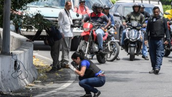 Venezuelan Scientific Police members (CICPC) check the surroundings of La Carlota military base in Caracas on May 2, 2019 after a day of violent clashes on the streets of the capital spurred by opposition leader Juan Guaido's call on the military to rise up against President Nicolas Maduro. - Two more opposition demonstrators, both minors, have died from injuries sustained in clashes with Venezuelan security forces, the opposition said Thursday, bringing the death toll in two days of unrest to four. (Photo by Federico PARRA / AFP) (Photo credit should read FEDERICO PARRA/AFP/Getty Images)