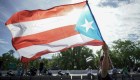 A protester waves the Puerto Rican flag in San Juan, Puerto Rico, July 22, 2019 on day 9th of continuous protests demanding the resignation of Governor Ricardo Rosselló. - Protests erupted last week after the leak of hundreds of pages of text chats on the encrypted messaging app Telegram in which Rossello and 11 other male administration members criticize officials, politicians and journalists. In one exchange, chief financial officer Christian Sobrino makes homophobic references to Latin superstar Ricky Martin. In another, a mocking comment is made about bodies piled up in the morgue after Hurricane Maria, which left nearly 3,000 dead. (Photo by eric rojas / AFP) (Photo credit should read ERIC ROJAS/AFP/Getty Images)