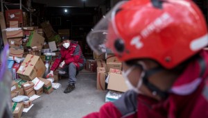 WUHAN, CHINA - JANUARY 29: (CHINA OUT) A courier organizes packages in an Express station on January 29, 2020 in Hubei Province, Wuhan, China. Due to a transit shut down and lack of supplies, couriers have became the city's suppliers. The 2019 coronavirus (2019-nCoV), which originated in Wuhan, China, has infected 6078 people and killed at least 132, mostly in China. (Photo by Getty Images)
