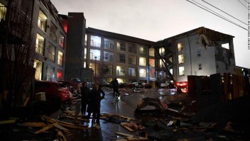 Debris is scattered across the parking lot of a damaged apartment building after a tornado hit Nashville in the early morning hours of Tuesday, March 3, 2020. (Courtney Pedroza/The Tennessean via AP)